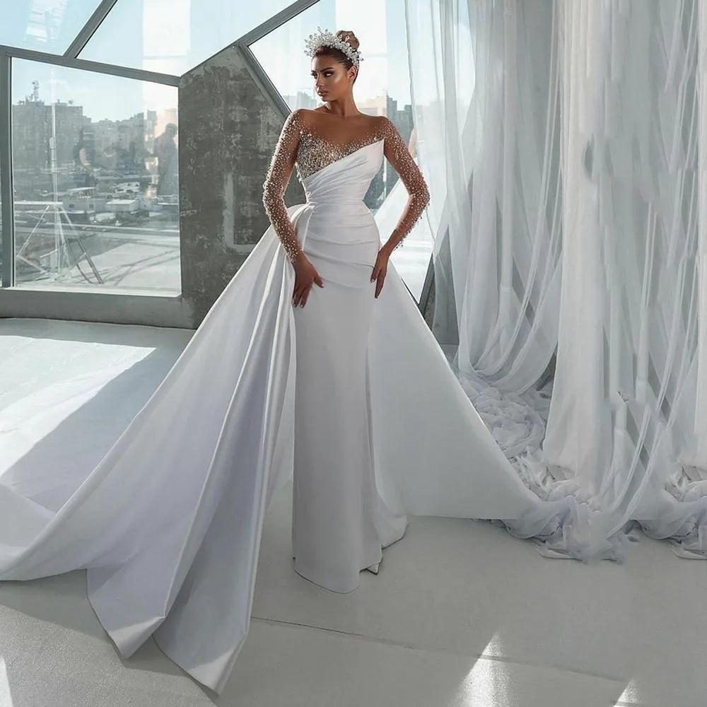 Royal Gown Elegant Mermaid Wedding Dress with Illusion Neckline, Beaded Long Sleeves, and a Detachable Overskirt Royal Gown Elegant Mermaid Wedding Dress with Illusion Neckline, Beaded Long Sleeves, and a Detachable Overskirt
